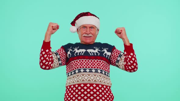 Grandfather Man in Sweater Christmas Santa Shouting Celebrating Success Winning Goal Achievemen alt