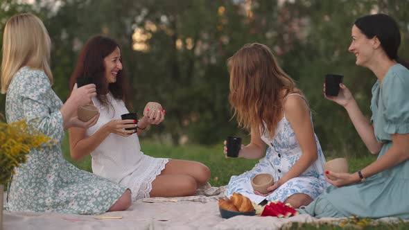 Young Women After Modeling From Clay Discuss the Resulting Products Drink Tea Coffee Drinks Laugh alt