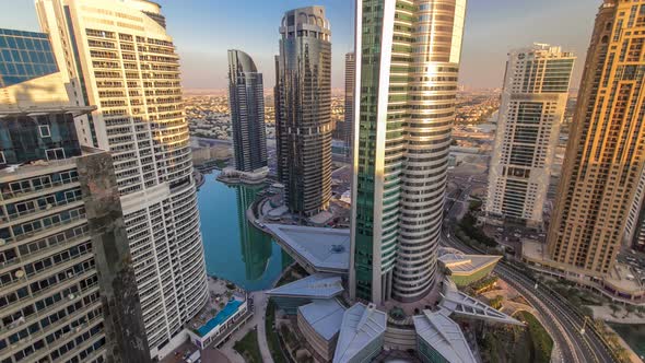 Top View of Buildings Jumeirah Lakes Towers with Traffic on the Road Sunset Timelapse alt