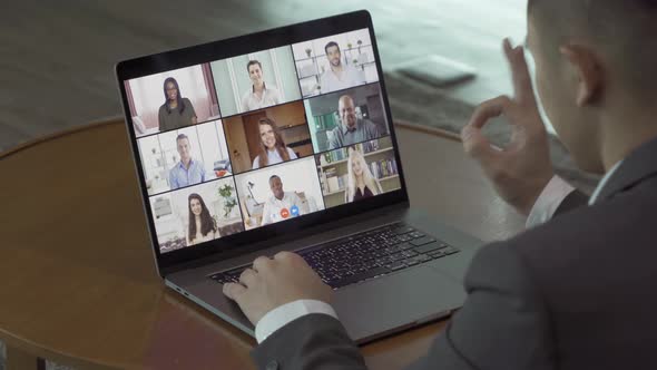 Asian man talking to multi ethnic group of business people working from home and office, talking alt