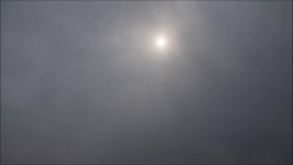 Time lapse: the sun shining through thik dense stormy snowing clouds
