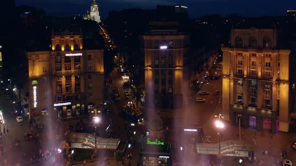 Aerial View of Night City with Colored Splashing Fountains alt