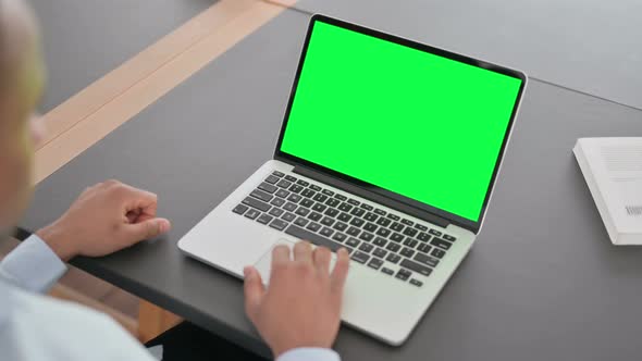 African Man Using Laptop with Green Chroma Key Screen alt