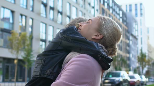 Glad Woman Hugging Female Child Outdoors, Mother Unconditional Love, Parenthood