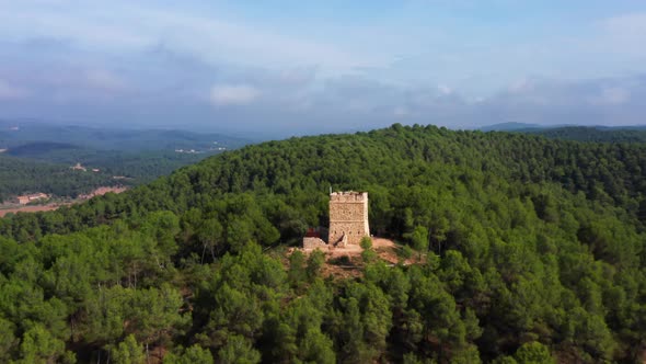 aerial drone shot of soldiers tower in avinyó dense natural green forest. mountains of catalonia spa alt