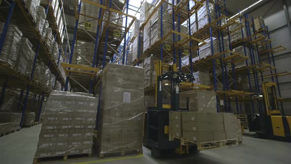 Timelapse of People using forklift in warehouse