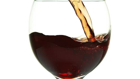 980016 Red Wine being poured into Glass, against White Background, Slow motion alt