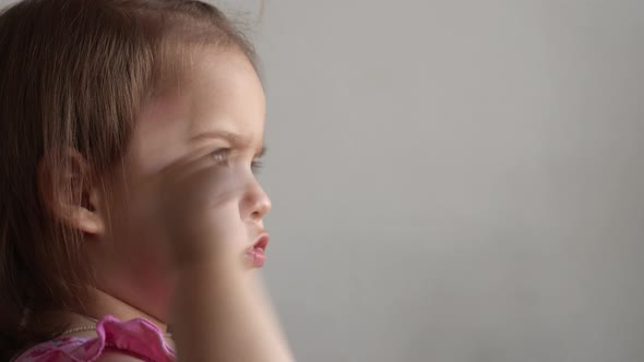 Small Toddler Girl Making Funny Expressive Grimace Face with Soft Toy Bear at Home alt