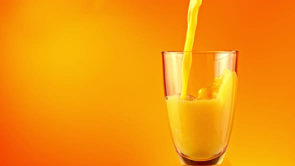Super Slow Motion Shot of Pouring Fresh Orange Juice Into Glass at 1000 Fps alt