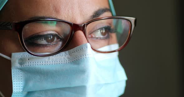 Young female medic, wearing a mask and glasses