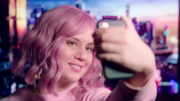 Pink-Haired Party Girl Takes Selfies on Smart Phone with Colorful Sci-Fi Scene in Background alt