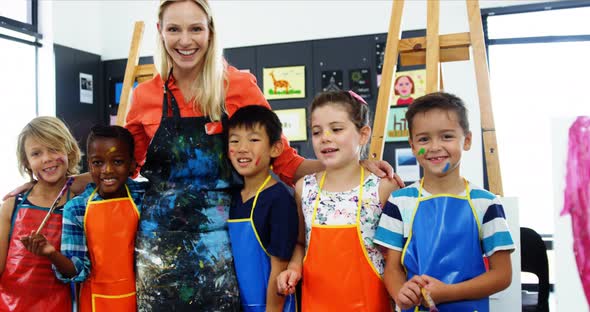 Teacher and schoolkid having fun in drawing class alt