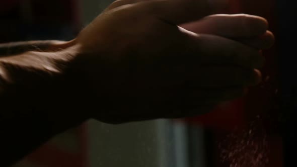 Weightlifter Rubs Hands with Magnesia, Claps His Hands. Cloud of Magnesia. alt
