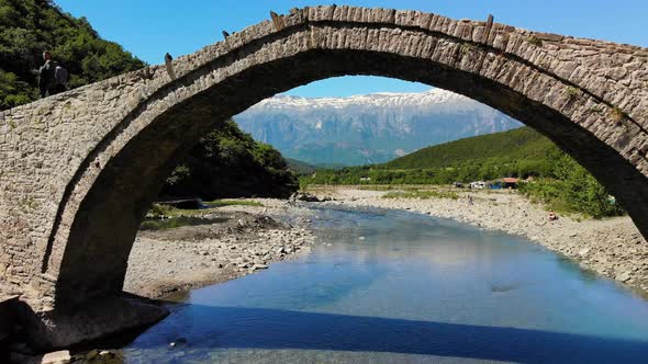 AERIAL Flying Under an Ancient Arched Stone Bridge in Albania