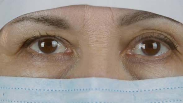 Close up of a caucasian female doctor looking at the camera. face of a woman in a medical protective alt