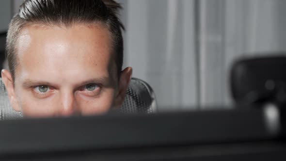 Sliding Cropped Shot of a Male Eyes Looking at Computer Monitor alt