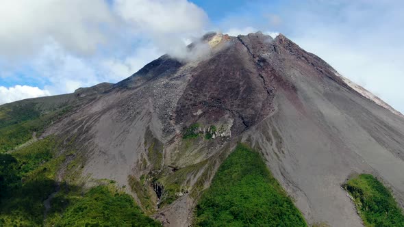 Majestic Mount Merapi volcano cone in clouds on Java, Indonesia, aerial view alt