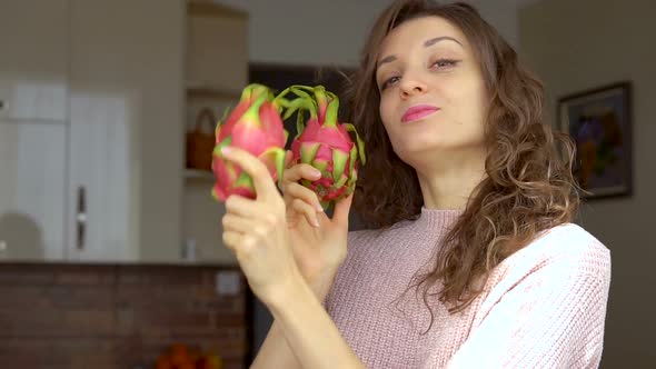 Young Girl is Holding Two Fresh Ripe Organic Dragon Fruits or Pitaya Pitahaya alt
