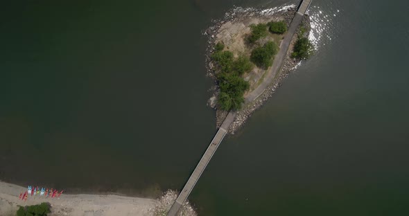 Top Down Aerial Panning View of a Small Bridge Over Water alt