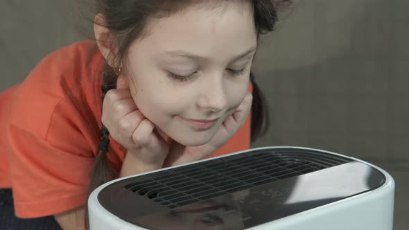 Child and air purifier. Home healthy life with air purifier. alt