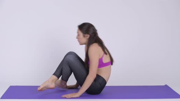 Young Beautiful Multi-ethnic Woman Doing Navasna Yoga Pose alt