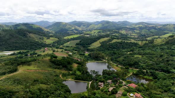 Aerial View of Valley with Lake, Forest and Villa in Tropical Country alt