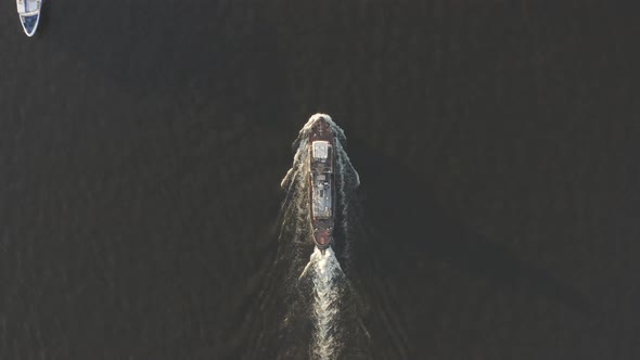 Aerial Shot of Cargo Ship Floats on the River or Sea. Freight Boat Carriage Goods. Drone Fly Over alt