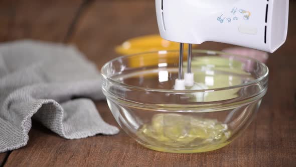 Beating A Egg Whites With A Mixer In A Glass Bowl