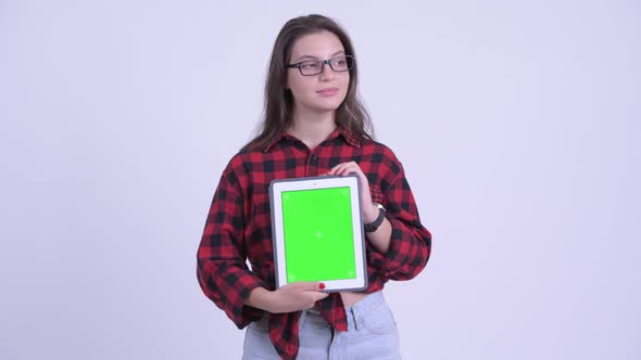 Happy Young Beautiful Hipster Woman Thinking While Showing Digital Tablet alt