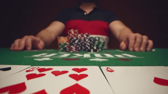 Close Up of Man Playing Card Game in Casino