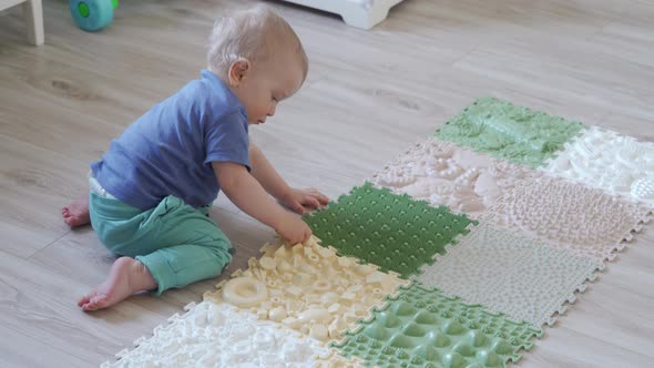 Small Child Walks Barefoot on a Massage Mat Orthopedic Massage Carpet for Legs alt