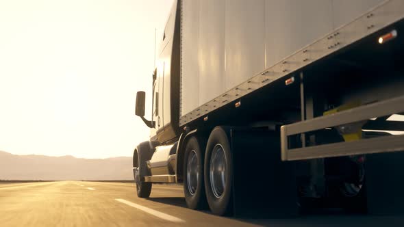 Truck Driving On Asphalt Road in Desert Landscape. Logistic, transportation. 4k alt