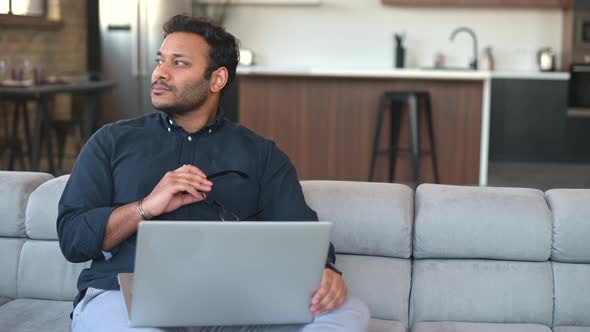 Multiethnic Hindu Freelancer Guy Using Laptop Computer at Home alt