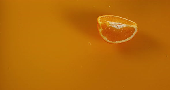 Orange, citrus sinensis, Fruit falling into Orange Juice, Slow Motion 4K alt
