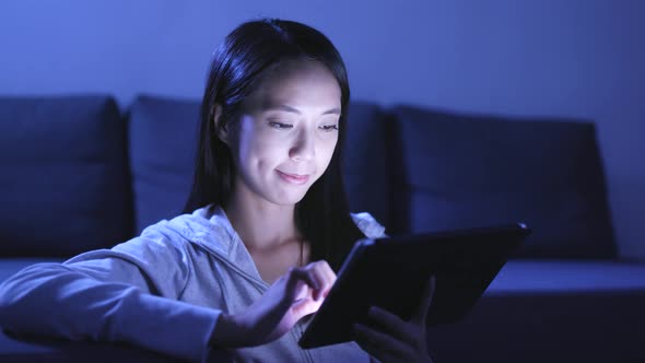 Woman Using Tablet Computer at Night 
