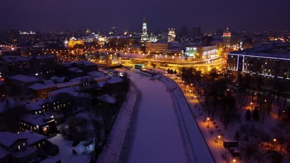 Evening illuminated Kharkiv city river aerial view
