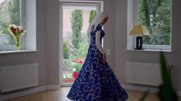 Charming Young Slim Muslim Woman in Hijab and Wedding Dress Spinning Looking at Camera alt