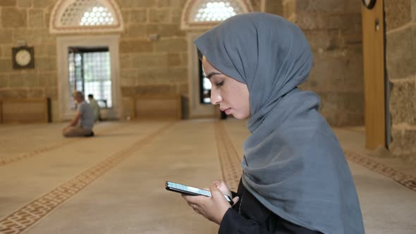 Praying at Mosque Young Muslim Woman Reading Islamic Holybook Smarthphone alt