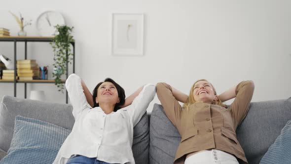 Positive Women Resting on Sofa