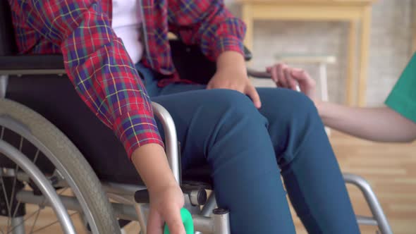 Teenage Girl Is Undergoing Rehabilitated By a Doctor After a Hand Injury with the Help of a Wrist alt