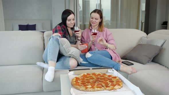 Two Friends Talk Cheerfully Drink Red Wine Eat Pizza and Relax