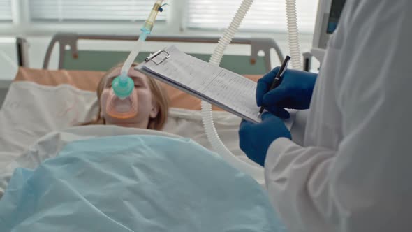 Doctor Writing Medical Records in ICU alt