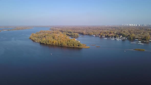 Aerial: Island on Dnipro river in Obolon district of Kiyv, autumn time alt