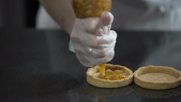 Decorating Tartlets with Jam. Using Cooking Bag, Confectioner Making Tartlet alt