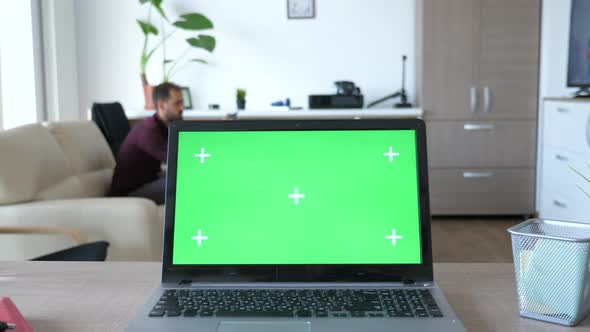 Laptop with Green Screen Chroma on It in the Middle of Living Room alt