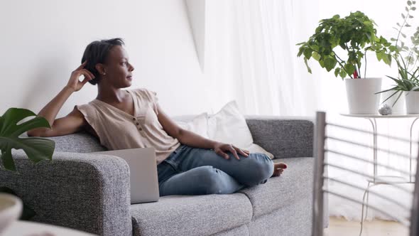 Pensive woman relaxing on the sofa alt