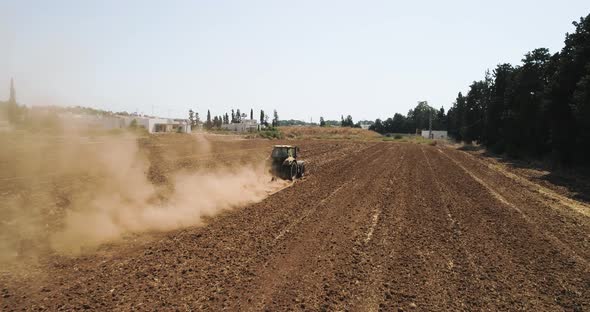Aerial view of a tractor ploughing an empty field, Kibbutz saar, Israel. alt