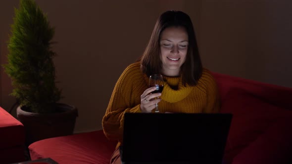 Happy Woman Talking on the Laptop with Someone