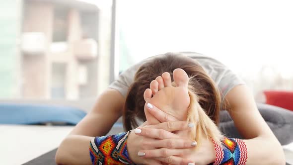 Close Up of Young Woman Practicing Yoga, Sitting in Head To Knee Forward Bend Exercise alt