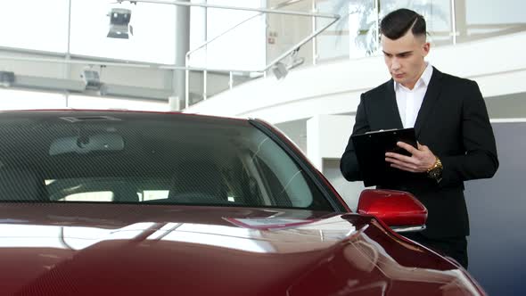 Auto business, car sales, seller with a folder in your hands alt
